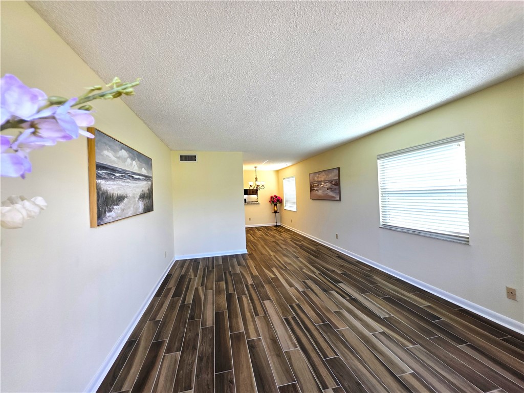 88 Crooked Tree Lane, Unit 107 Vero Beach, FL 32962 - Photo 13 of 33 a view of a house with wooden floor