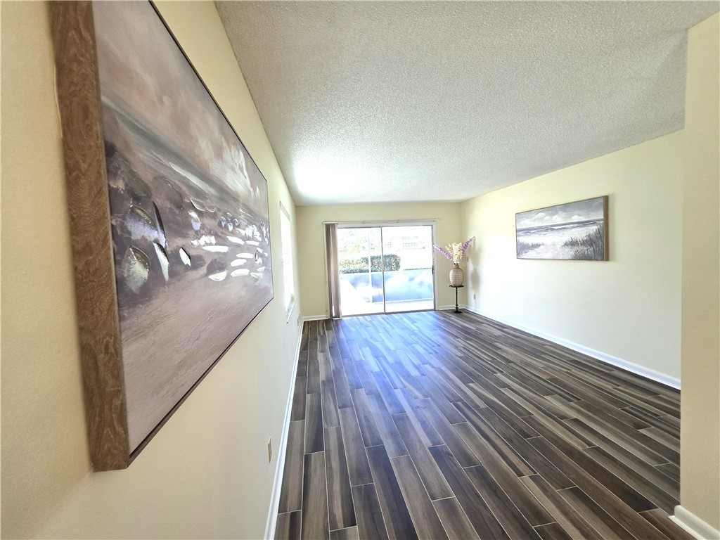 88 Crooked Tree Lane, Unit 107 Vero Beach, FL 32962 - Photo 15 of 33 a view of empty room with wooden floor