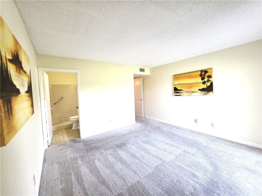 88 Crooked Tree Lane, Unit 107 Vero Beach, FL 32962 - Photo 19 of 33 a view of a big room with wooden floor and windows