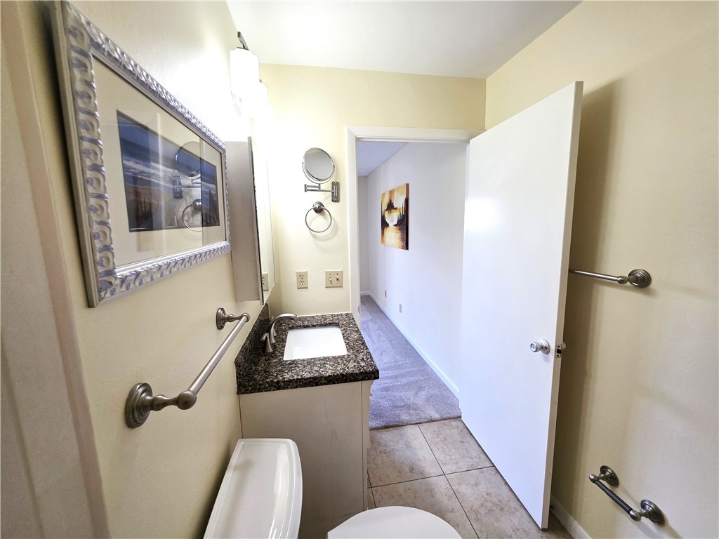 88 Crooked Tree Lane, Unit 107 Vero Beach, FL 32962 - Photo 21 of 33 a bathroom with sink and mirror with toilet
