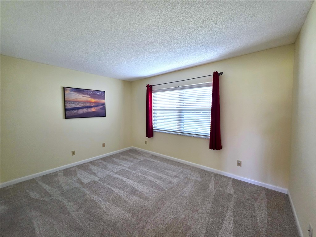 88 Crooked Tree Lane, Unit 107 Vero Beach, FL 32962 - Photo 24 of 33 a view of an empty room with a window