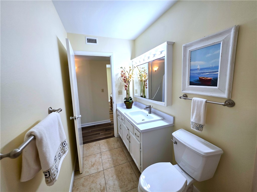 88 Crooked Tree Lane, Unit 107 Vero Beach, FL 32962 - Photo 25 of 33 a bathroom with a toilet sink and mirror