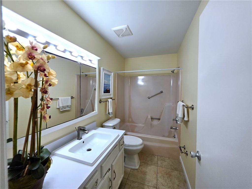 88 Crooked Tree Lane, Unit 107 Vero Beach, FL 32962 - Photo 26 of 33 a bathroom with a sink a toilet a mirror and shower