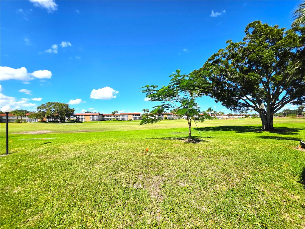 88 Crooked Tree Lane, Unit 107 Vero Beach, FL 32962 - Photo 29 of 33 a view of a golf course with a lake