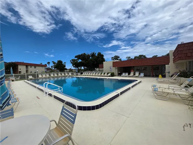 a view of yard with swimming pool and green space