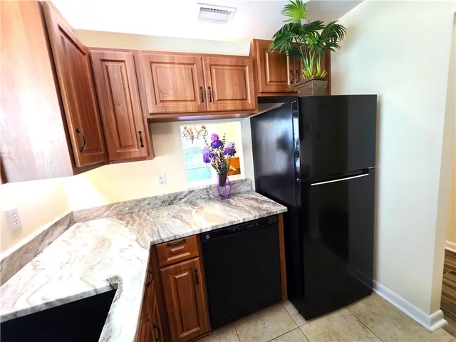 a kitchen with a refrigerator and a sink