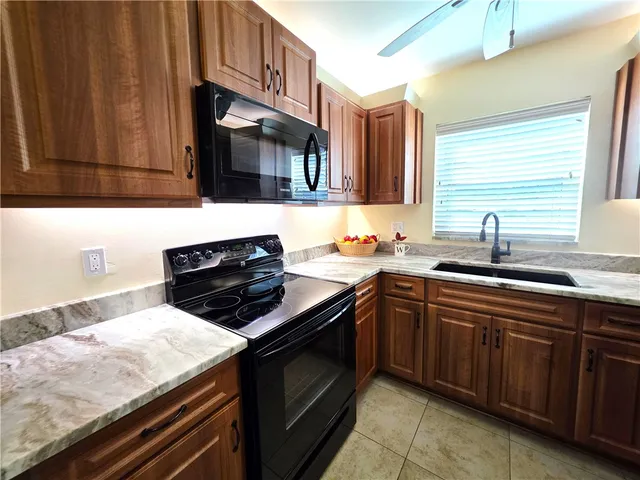 a kitchen with a sink stove and microwave
