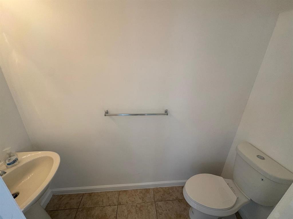 14044 Southwest 276th Way Homestead, FL 33032 - Photo 11 of 26 a bathroom with a toilet and sink