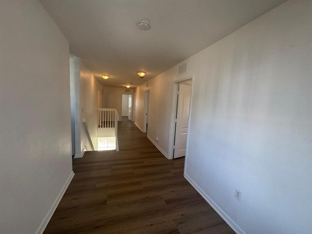 14044 Southwest 276th Way Homestead, FL 33032 - Photo 14 of 26 a view of a hallway with wooden floor