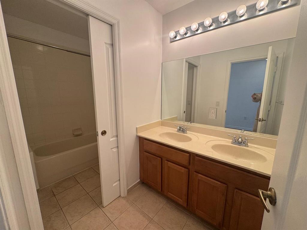 14044 Southwest 276th Way Homestead, FL 33032 - Photo 16 of 26 a bathroom with a sink and a mirror