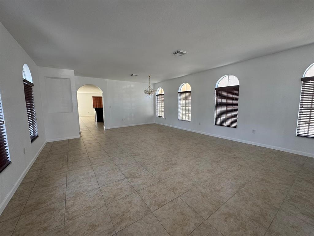 14044 Southwest 276th Way Homestead, FL 33032 - Photo 3 of 26 a view of a big room with windows and chandelier