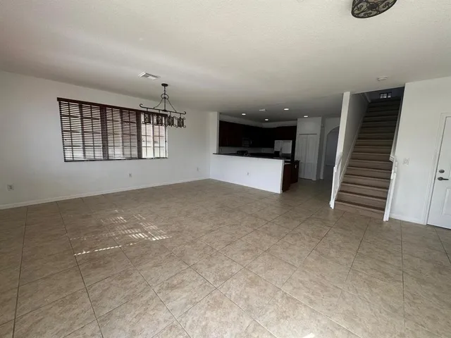 a view of a livingroom with furniture and staircase
