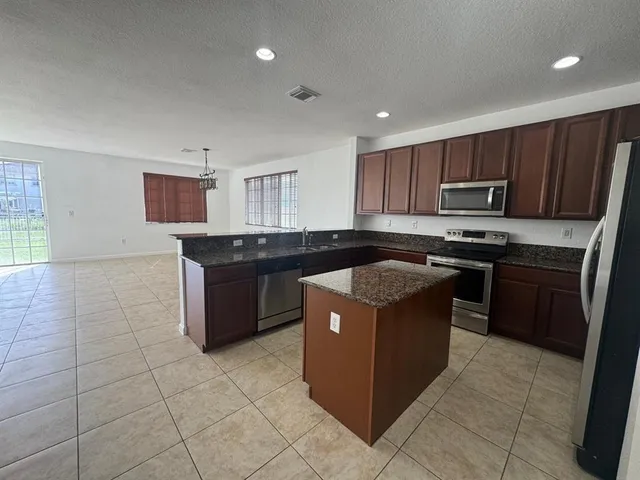 a kitchen with a stove top oven sink and cabinets
