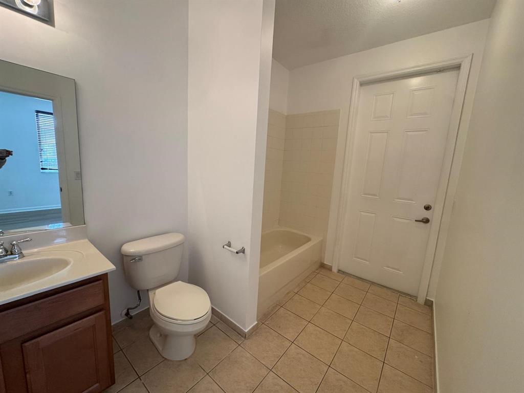 14044 Southwest 276th Way Homestead, FL 33032 - Photo 9 of 26 a bathroom with a toilet a sink and shower