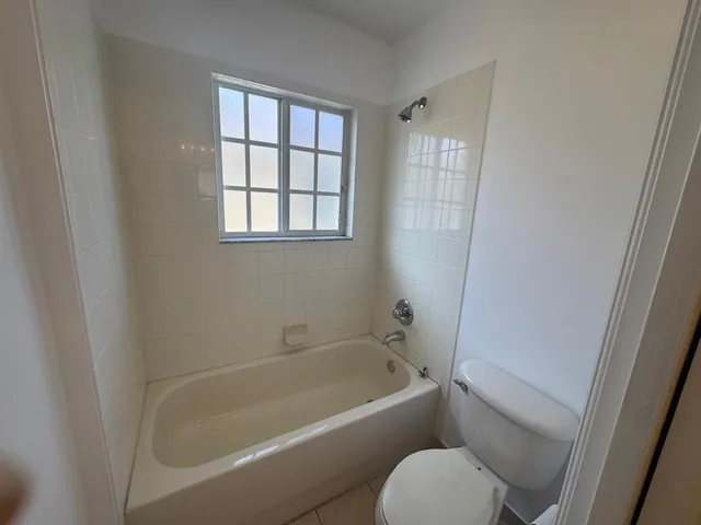 a white bath tub sitting next to a toilet