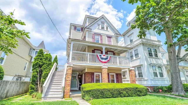 a view of a brick building next to a yard