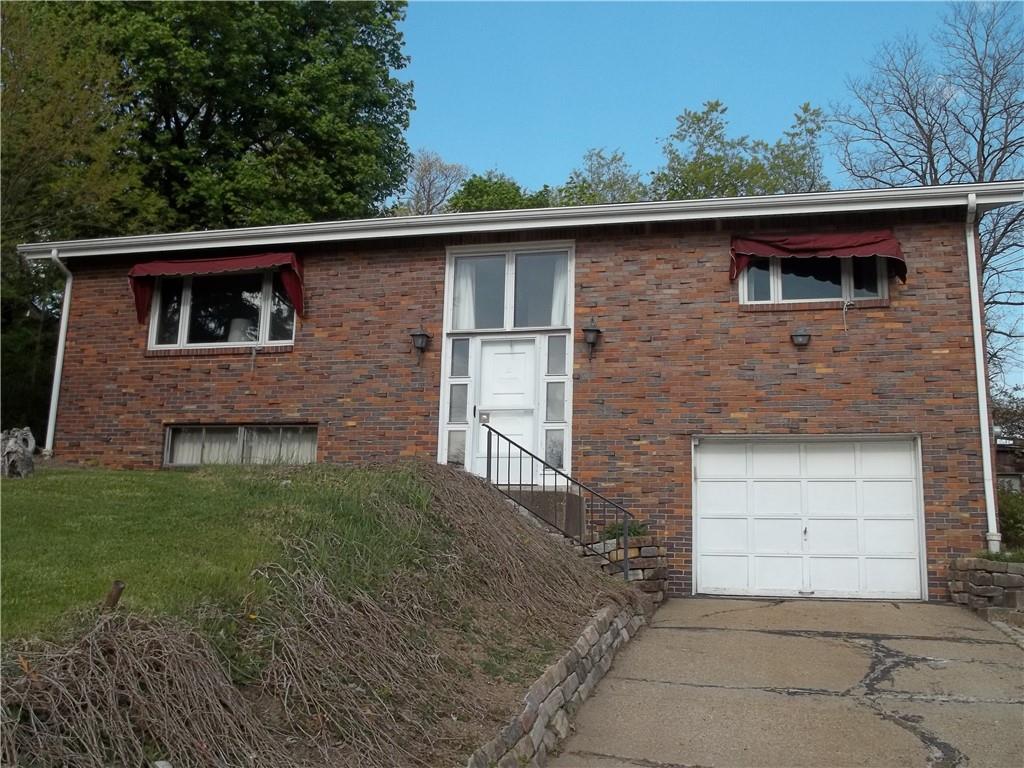596 Wible Run Road Pittsburgh, PA 15209 - Photo 1 of 21 a front view of a house with a garden