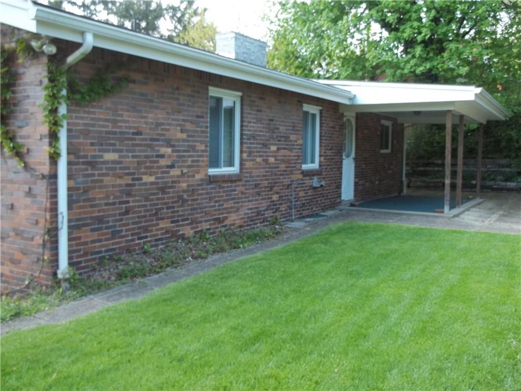 596 Wible Run Road Pittsburgh, PA 15209 - Photo 18 of 21 a brick house with a yard