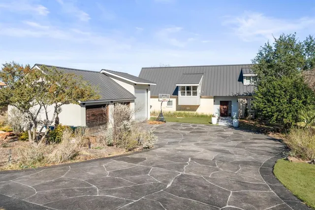 a view of a house with backyard and sitting area
