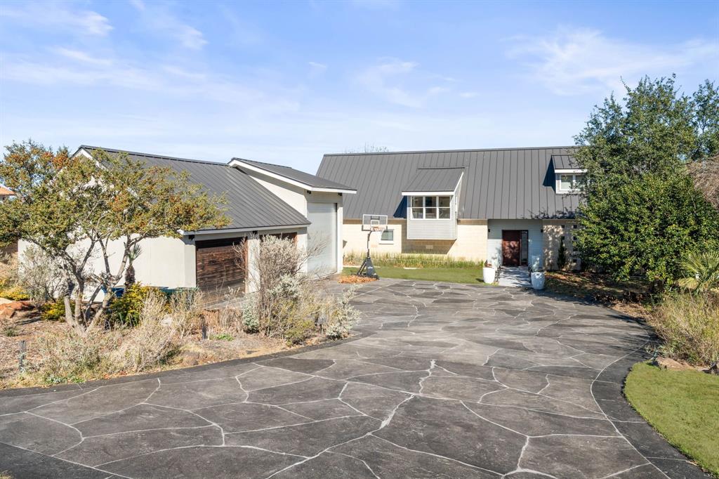 a view of a house with backyard and sitting area