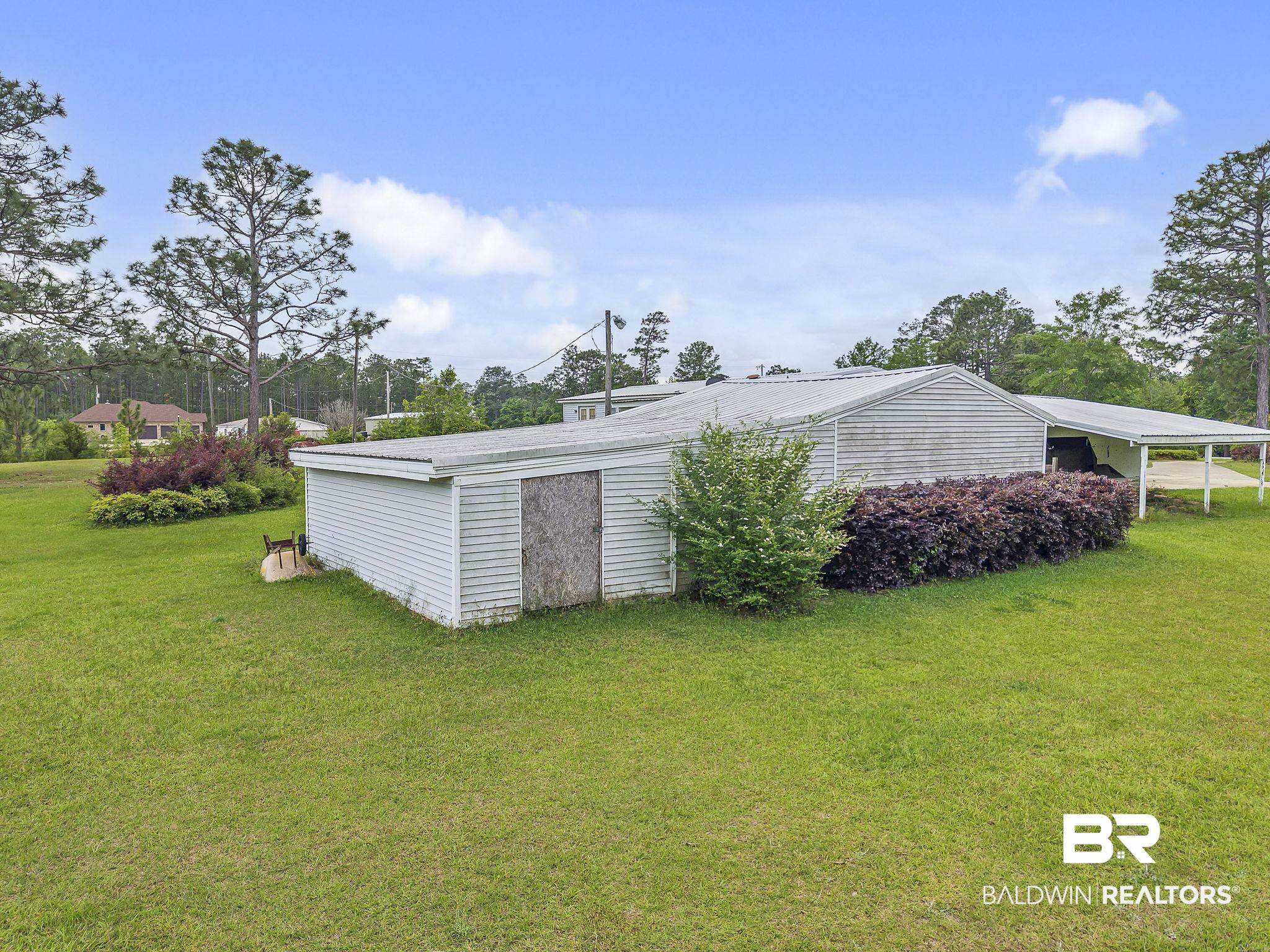 29792 County Road 65 Loxley, AL 36551 - Photo 20 of 39 View of side of property featuring a carport and a yard