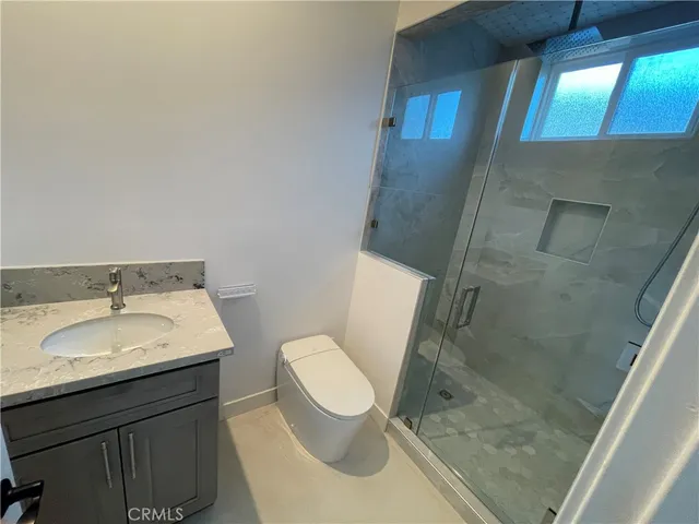 a bathroom with toilet sink and mirror