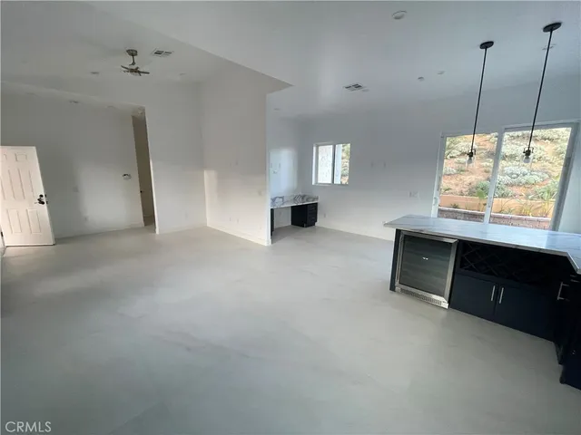 a living room with furniture window and a dresser