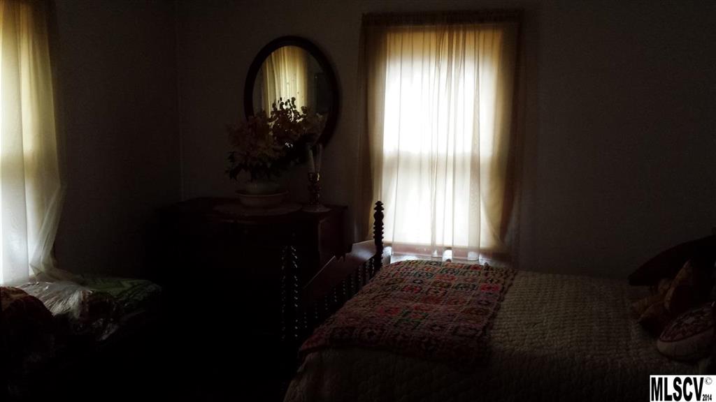 3407 Deerbrook Road Lenoir, NC 28645 - Photo 12 of 22 a bedroom with a bed next to a window