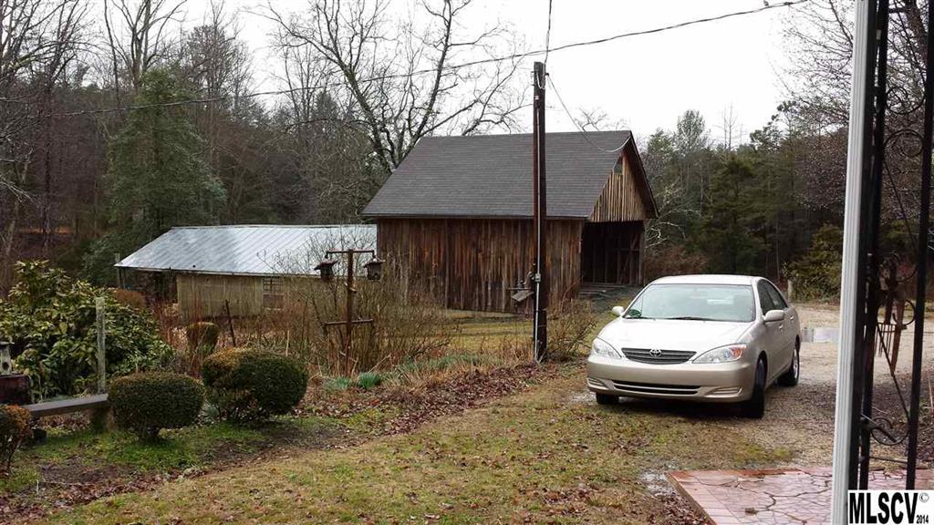 3407 Deerbrook Road Lenoir, NC 28645 - Photo 17 of 22 a white house covered with tall trees