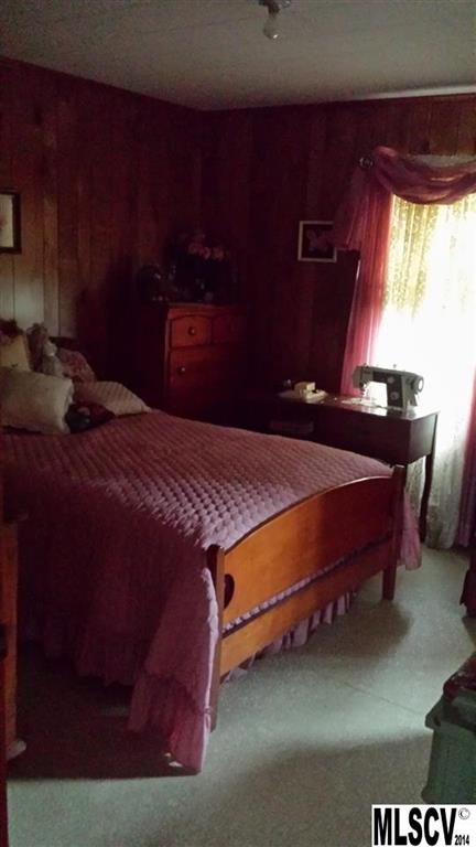 3407 Deerbrook Road Lenoir, NC 28645 - Photo 7 of 22 a bed sitting in a bedroom next to a window