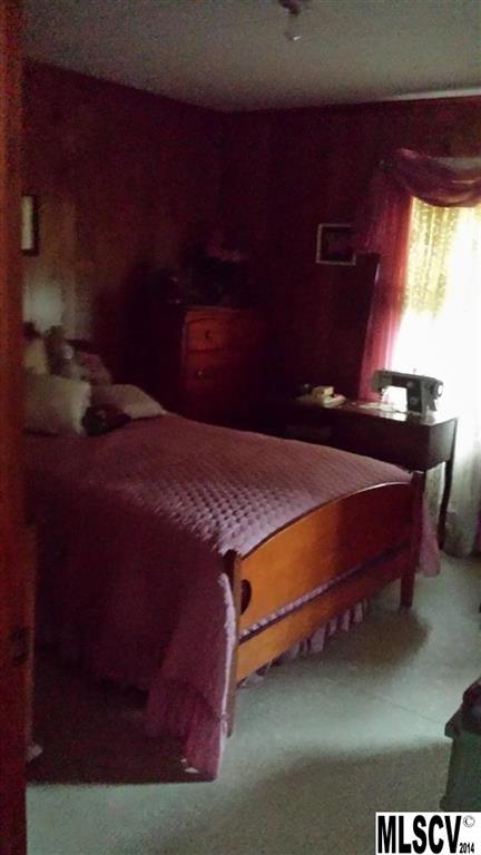 3407 Deerbrook Road Lenoir, NC 28645 - Photo 8 of 22 a bed sitting in a bedroom next to a window