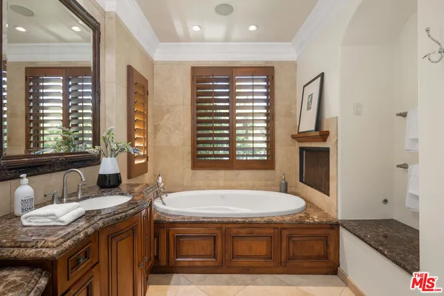 a spacious bathroom with a granite countertop tub and a sink