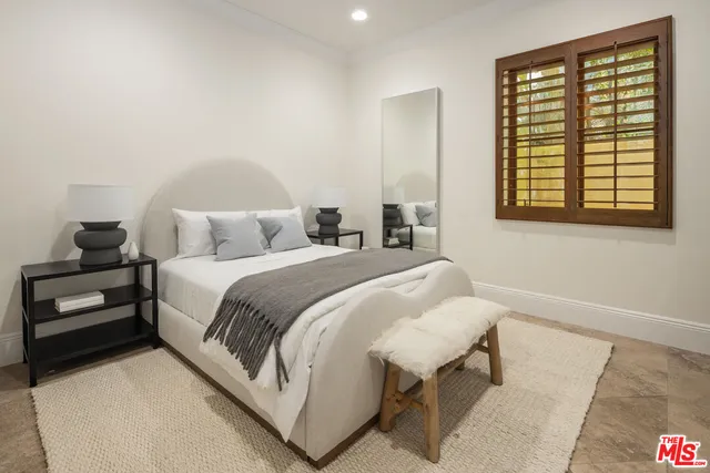 a bedroom with a bed and a night stand