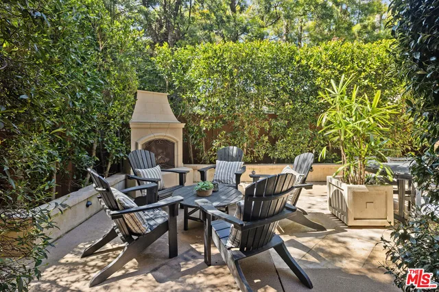 a view of a patio with table and chairs and potted plants