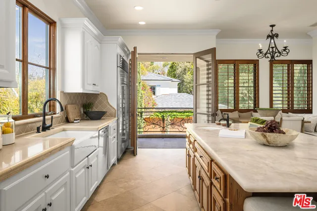 a kitchen with sink cabinets and large window