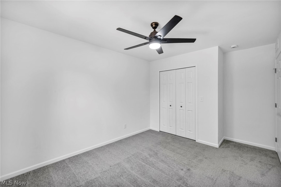 7602 Hickory Road Bedford, OH 44146 - Photo 20 of 36 Unfurnished bedroom with light colored carpet, a closet, and a ceiling fan