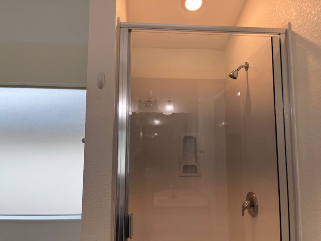 505 Ibis Falls Loop Jarrell, TX 76537 - Photo 15 of 29 a bathroom with a glass shower door