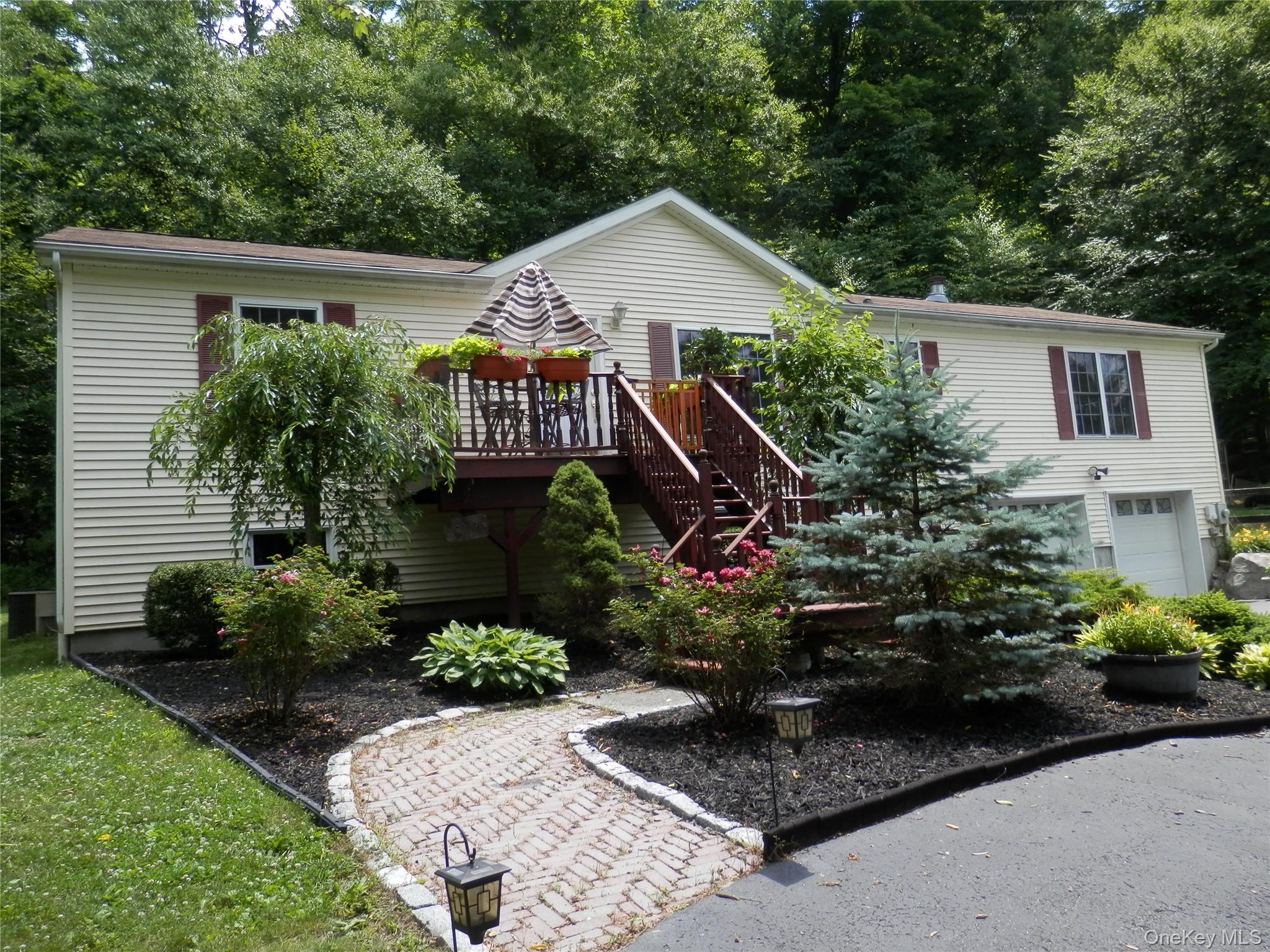 590 Farm To Market Road Brewster, NY 10509 - Photo 5 of 32 a front view of a house with a yard and potted plants