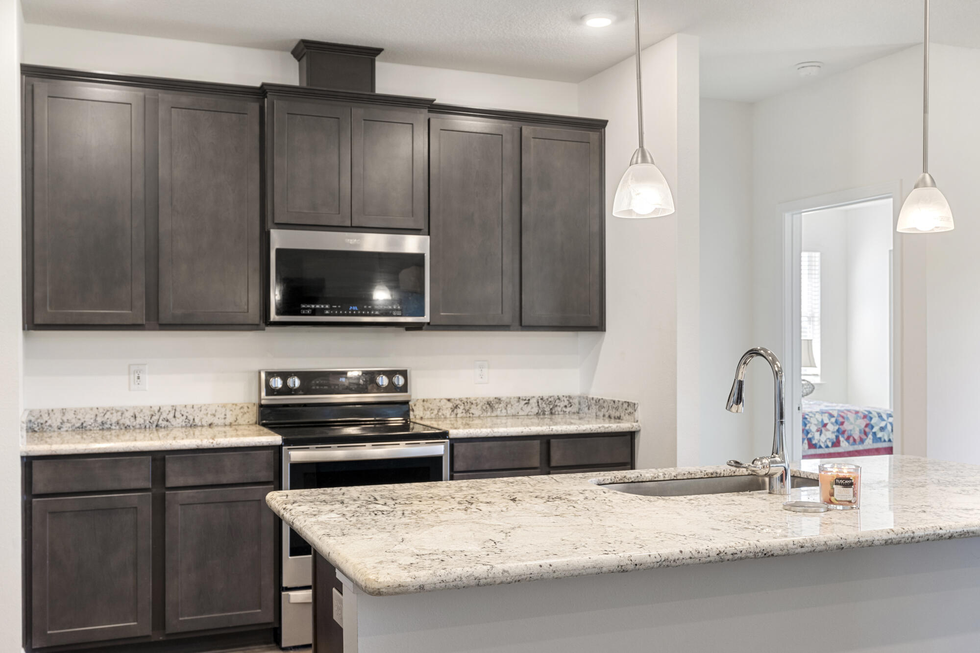 170 Double Eagle Court Freeport, FL 32439 - Photo 14 of 46 a kitchen with granite countertop a sink and a stove top oven with wooden floor