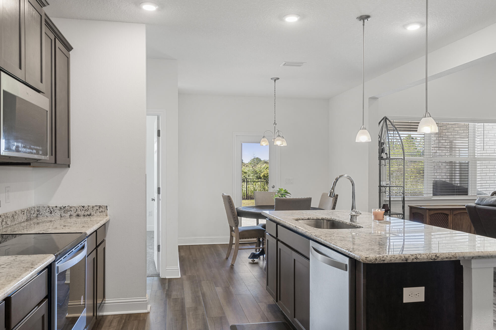 170 Double Eagle Court Freeport, FL 32439 - Photo 15 of 46 a kitchen with stainless steel appliances granite countertop a sink a stove and a wooden floors