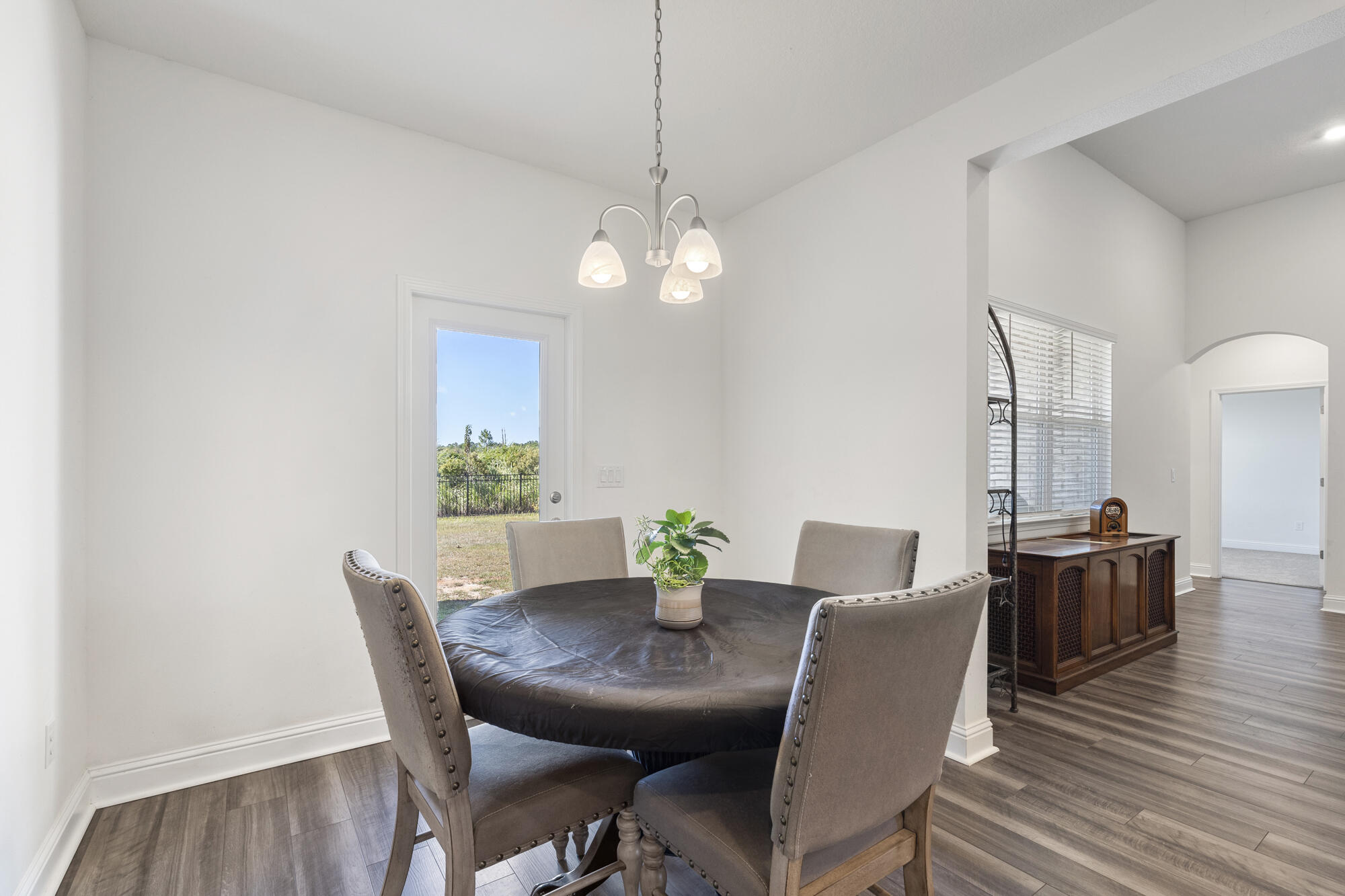 170 Double Eagle Court Freeport, FL 32439 - Photo 17 of 46 a view of a dining room with furniture wooden floor and chandelier