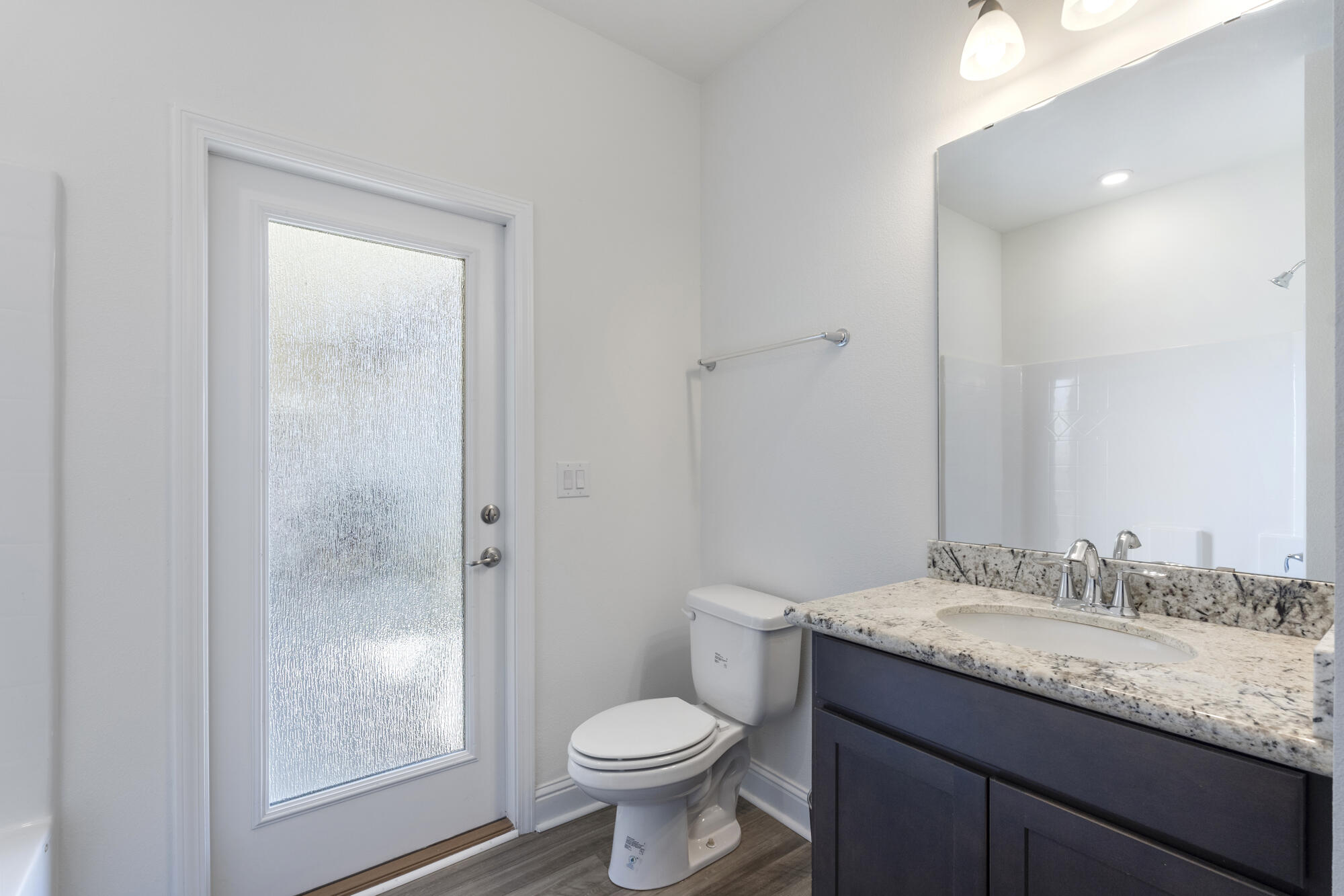 170 Double Eagle Court Freeport, FL 32439 - Photo 27 of 46 a bathroom with a granite countertop toilet a sink and a mirror