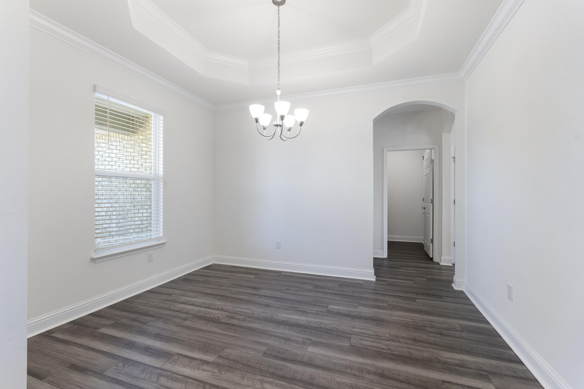 170 Double Eagle Court Freeport, FL 32439 - Photo 6 of 46 a view of a hallway with wooden floor and a chandelier