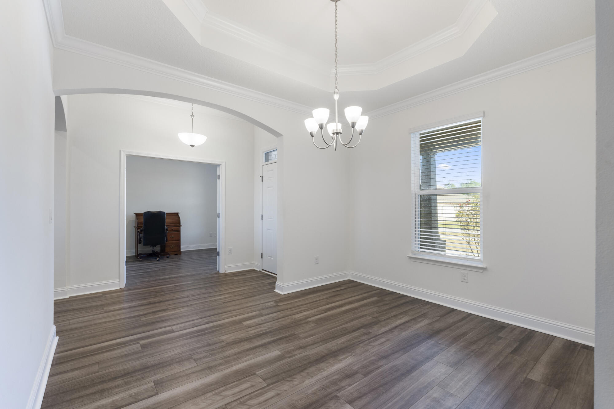 170 Double Eagle Court Freeport, FL 32439 - Photo 7 of 46 a view of a room with wooden floor and chandelier