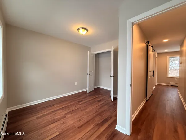 a view of a hallway with wooden floor