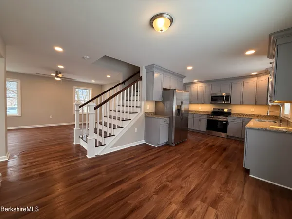 a view of kitchen with wooden floor and electronic appliances