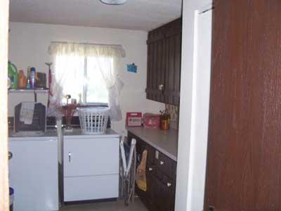 6510 Ashue Road Wapato, WA 98951 - Photo 8 of 18 a utility room with cabinets washer and dryer