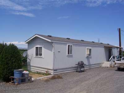 6510 Ashue Road Wapato, WA 98951 - Photo 10 of 18 a view of a house with a backyard and parking