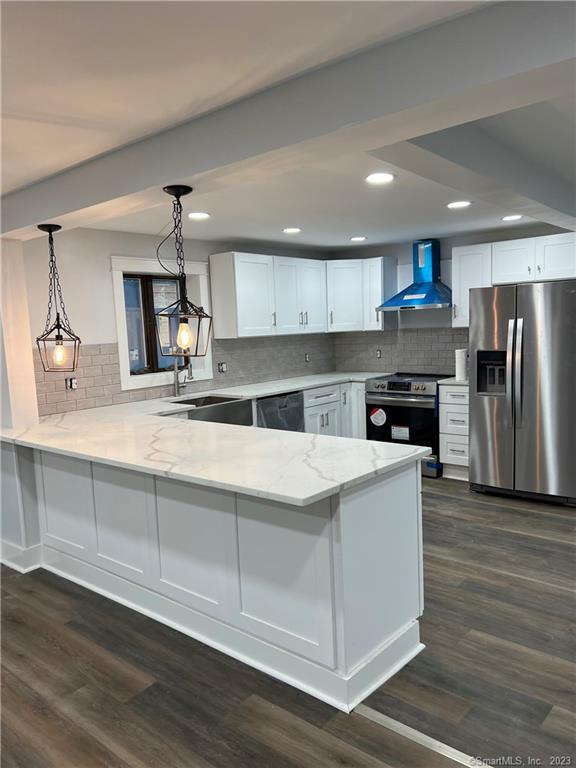 a kitchen with kitchen island a sink and wooden floor