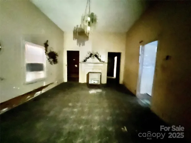 a view of an empty room with a fireplace